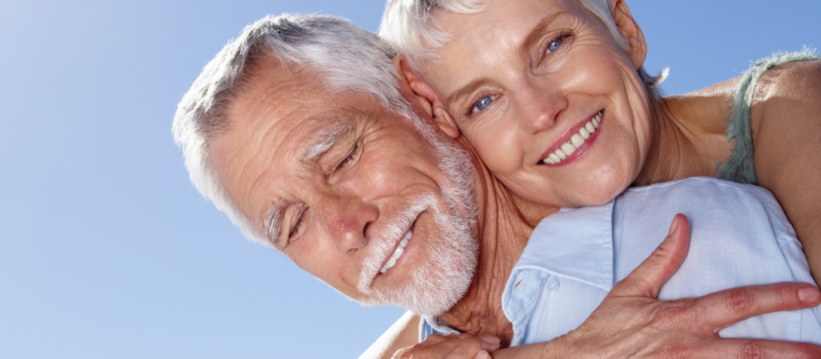 Portrait of a senior woman hugging a man