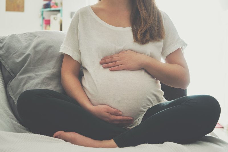 Pregnant woman rubbing her stomach